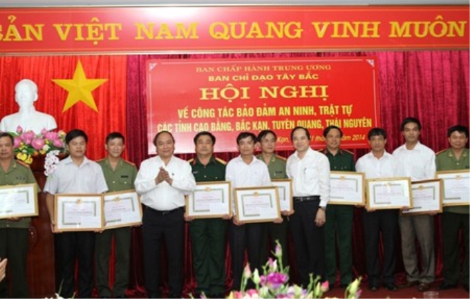 Phó Thủ tướng Nguyễn Xuân Phúc tặng bằng khen của Ban Chỉ đạo Tây Bắc cho các đơn vị, cá nhân có thành tích xuất sắc trong công tác bảo đảm ANTT. Ảnh: chinhphu.vn