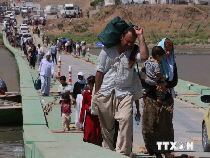 Cộng đồng người Yazidi trở về Iraq sau khi phải chạy sang Syria do lo ngại phiến quân ISIS. (Ảnh: AFP/TTXVN)