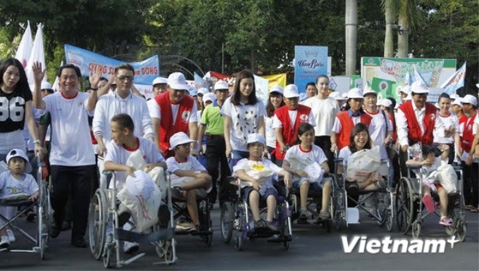 Các tình nguyện viên đi bộ vì nạn nhân chất độc da cam và người khuyết tật nghèo. (Ảnh: Vietnam+)