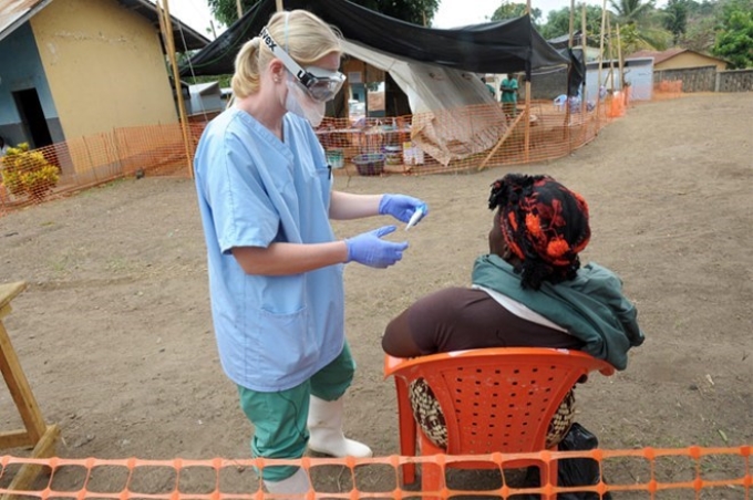 Nhân viên y tế của Tổ chức Bác sỹ không biên giới chăm sóc cho bệnh nhân nghi nhiễm Ebola. (Nguồn: AFP)