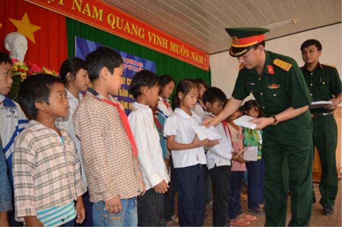 Đại diện Ban Thanh niên Quân đội trao học bổng Vừ A Dính tặng 50 học sinh nghèo trên địa bàn xã Cư Drăm, huyện Krông Bông, tỉnh Đắc Lắc. Ảnh: Văn Chung