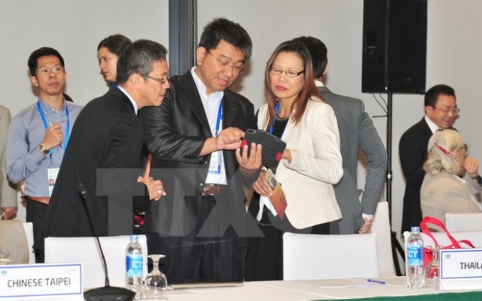 Các đại biểu đại diện các nền kinh tế APEC bên lề cuộc họp. (Ảnh: TTXVN)
