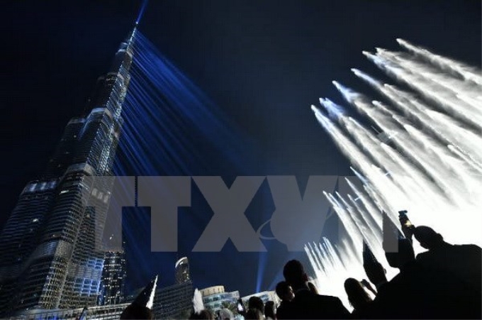 Màn trình diễn ánh sáng và âm thanh đón Năm mới ở tòa tháp Burj Khalifa, Dubai, UAE. (Nguồn: AFP/TTXVN)