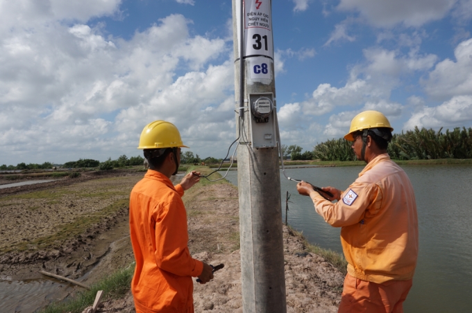 Công nhân Điện lực Châu Thành lắp đặt công tơ cho các hộ dân ấp Cồn Phụng