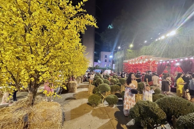 Người dân Thành phố Hồ Chí Minh náo nức chụp ảnh lưu niệm bên tiểu cảnh mùa Xuân tại Lễ hội Tết Việt lần 3 năm 2022. (Ảnh: Mỹ Phương/TTXVN)