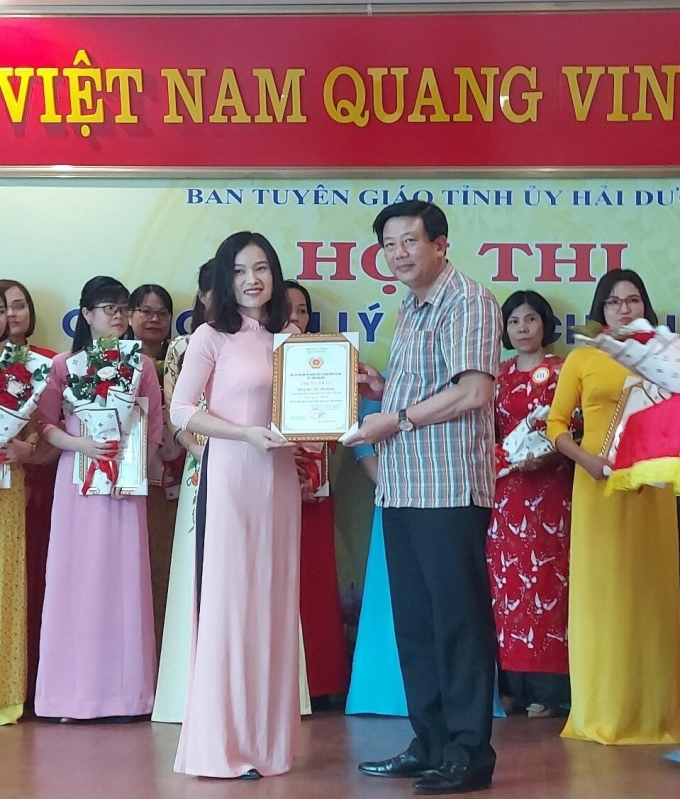 Đồng chí Nguyễn Quang Phúc, Trưởng ban Tuyên giáo Tỉnh uỷ, Trưởng ban Tổ chức Hội thi trao giải Nhất cho thí sinh Hà Thị Giang - Giảng viên Trung tâm chính trị huyện Nam Sách.