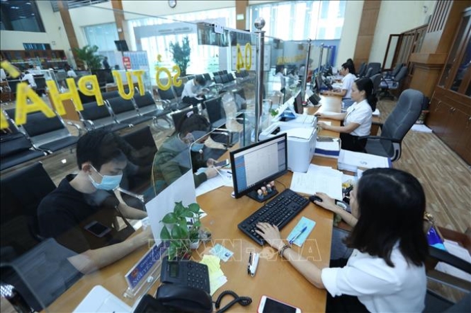 Tiếp nhận và giải quyết hồ sơ của các sở, ban, ngành tại Trung tâm Phục vụ hành chính công tỉnh Bắc Giang. (Ảnh: TTXVN)