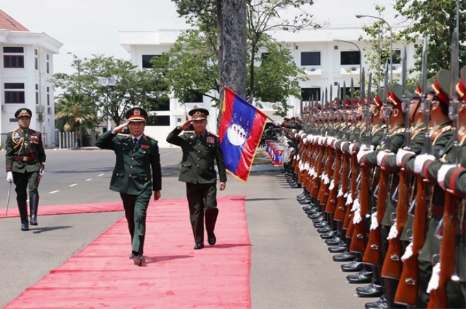 Thượng tướng Nguyễn Tân Cương, Tổng Tham mưu trưởng, Thứ trưởng Bộ Quốc phòng duyệt đội danh dự trong lễ đón chính thức tại Bộ Quốc phòng Lào vào chiều 10/5 tại thủ đô Vientiane. (Ảnh: TTXVN)