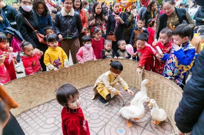 Thiếu nhi tham gia các trò chơi dân gian, gói bánh chưng… là những hoạt động được các trường trên địa bàn tỉnh Nghệ An tổ chức, với ý nghĩa giáo dục thế hệ trẻ tìm về những giá trị cổ truyền của dân tộc, đặc biệt là ngày Tết Nguyên đán. Ảnh tư liệu: Bích Huệ/TTXVN